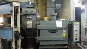 A large machine in a room with other machinery.