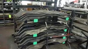 A stack of tires with green tags on them.